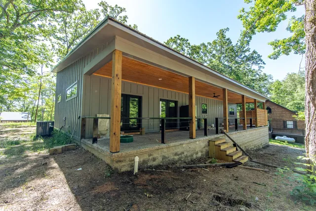 a view of a house with backyard and sitting area