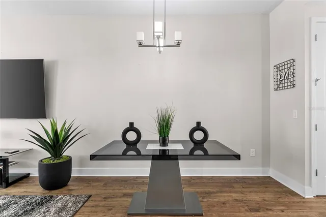 a dining room with furniture and wooden floor
