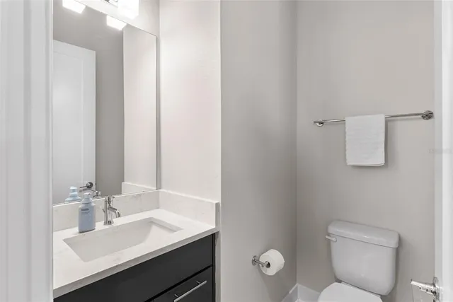 a bedroom with a bed and a flat tv screen on dresser