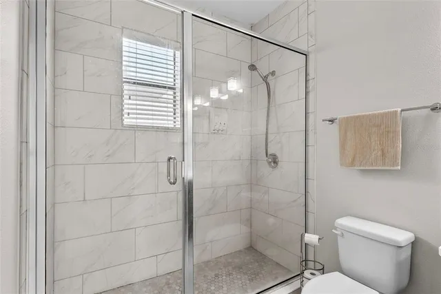 a bathroom with a sink a light fixture and a mirror