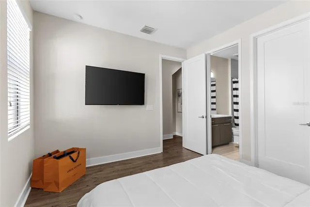 a bathroom with a sink a toilet a mirror and shower curtain