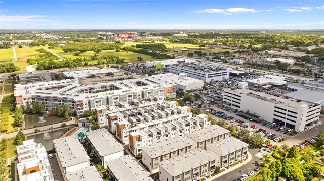 an aerial view of residential building with parking and yard