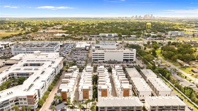 an aerial view of residential building with parking and yard