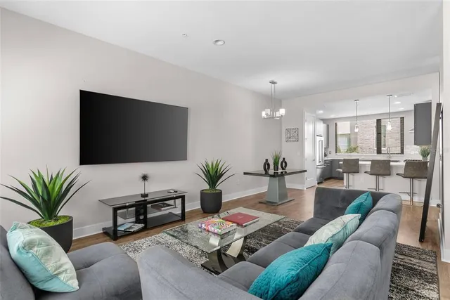 a living room with furniture and wooden floor