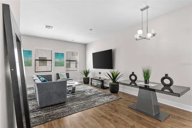 a kitchen with stainless steel appliances kitchen island granite countertop a refrigerator and a sink