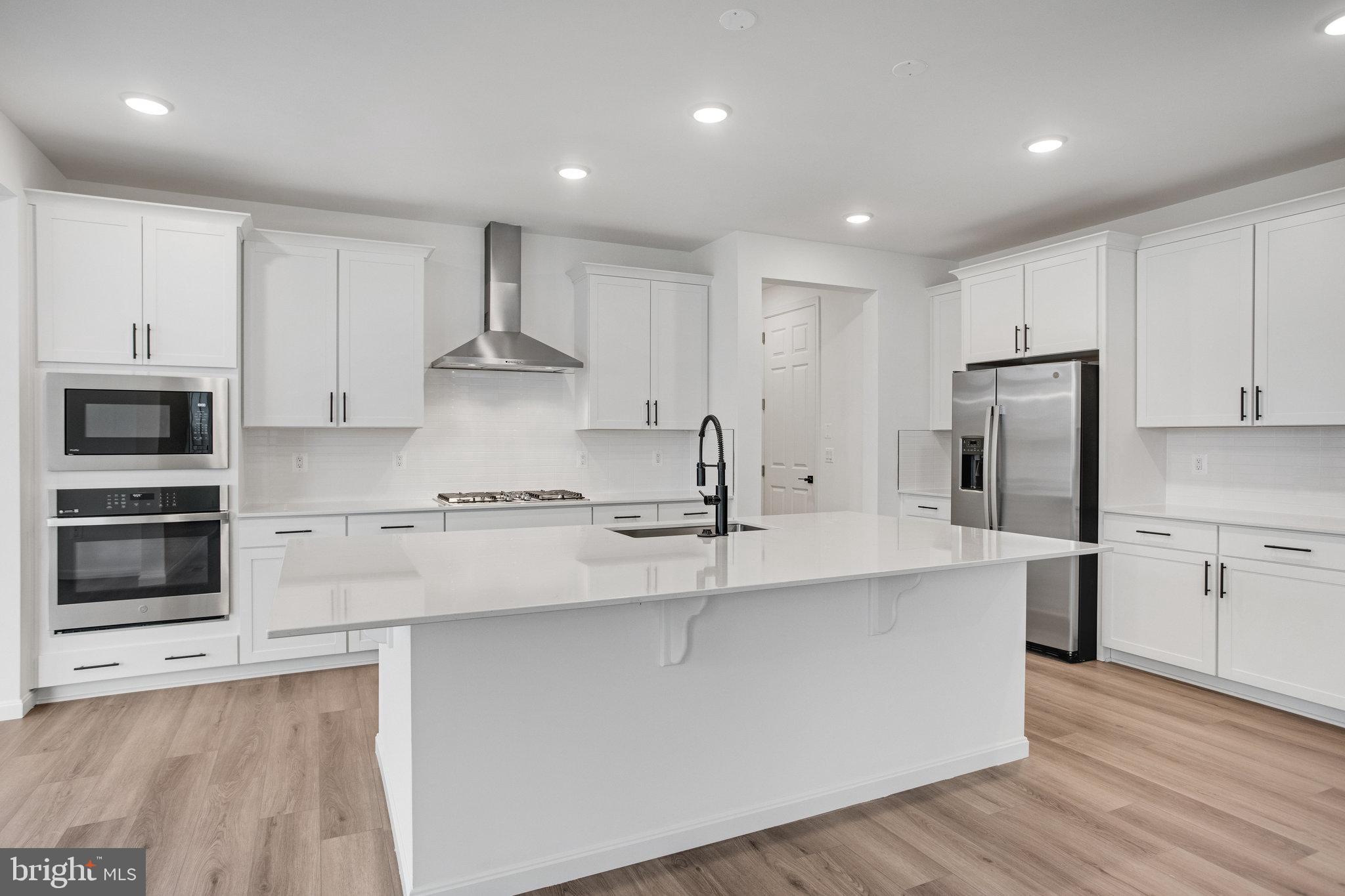 2009 Divot Drive Culpeper, VA 22701 - Photo 13 of 46 a kitchen with stainless steel appliances granite countertop a stove a sink and a refrigerator