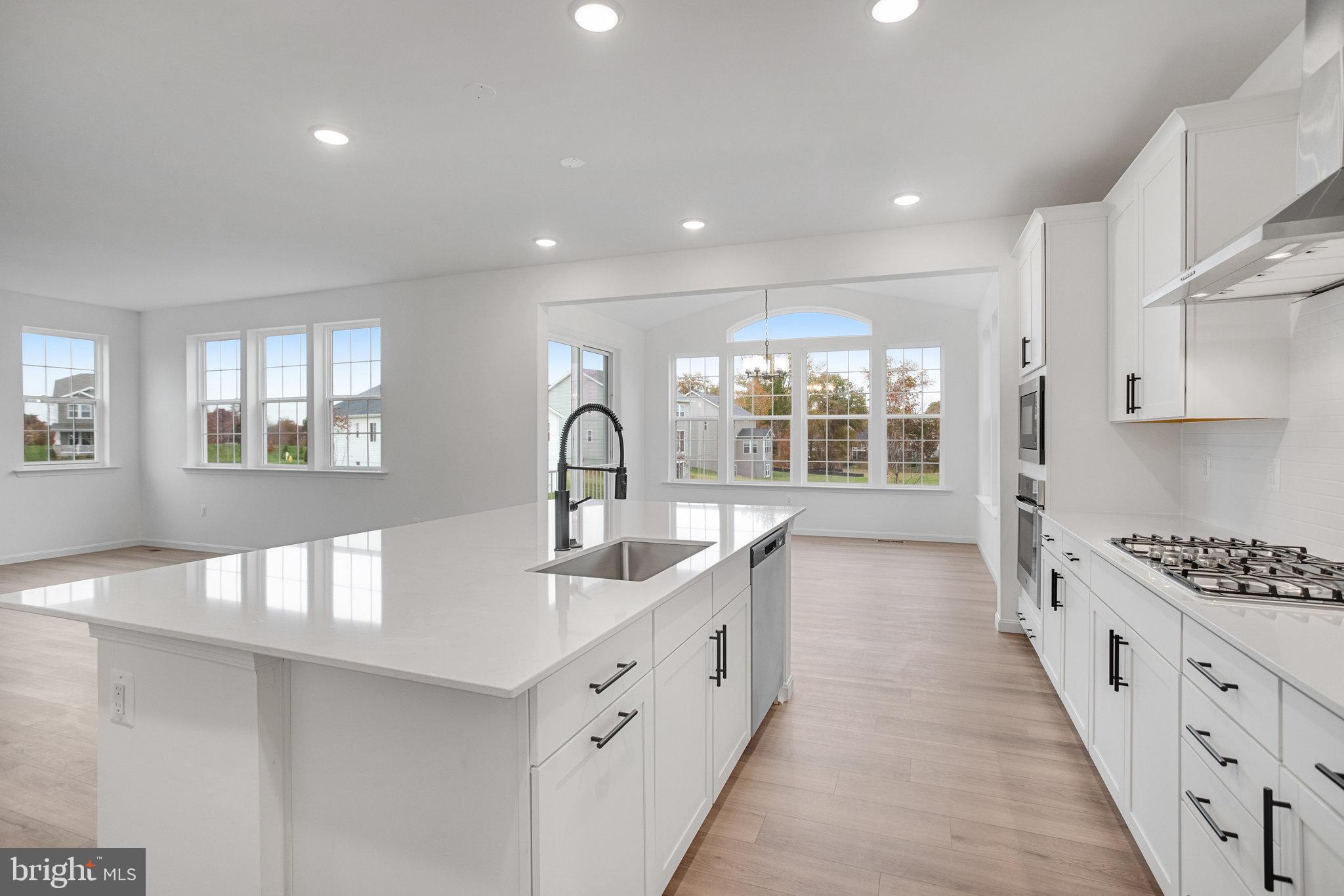 2009 Divot Drive Culpeper, VA 22701 - Photo 15 of 46 a large kitchen with stainless steel appliances granite countertop a lot of counter space and wooden floors