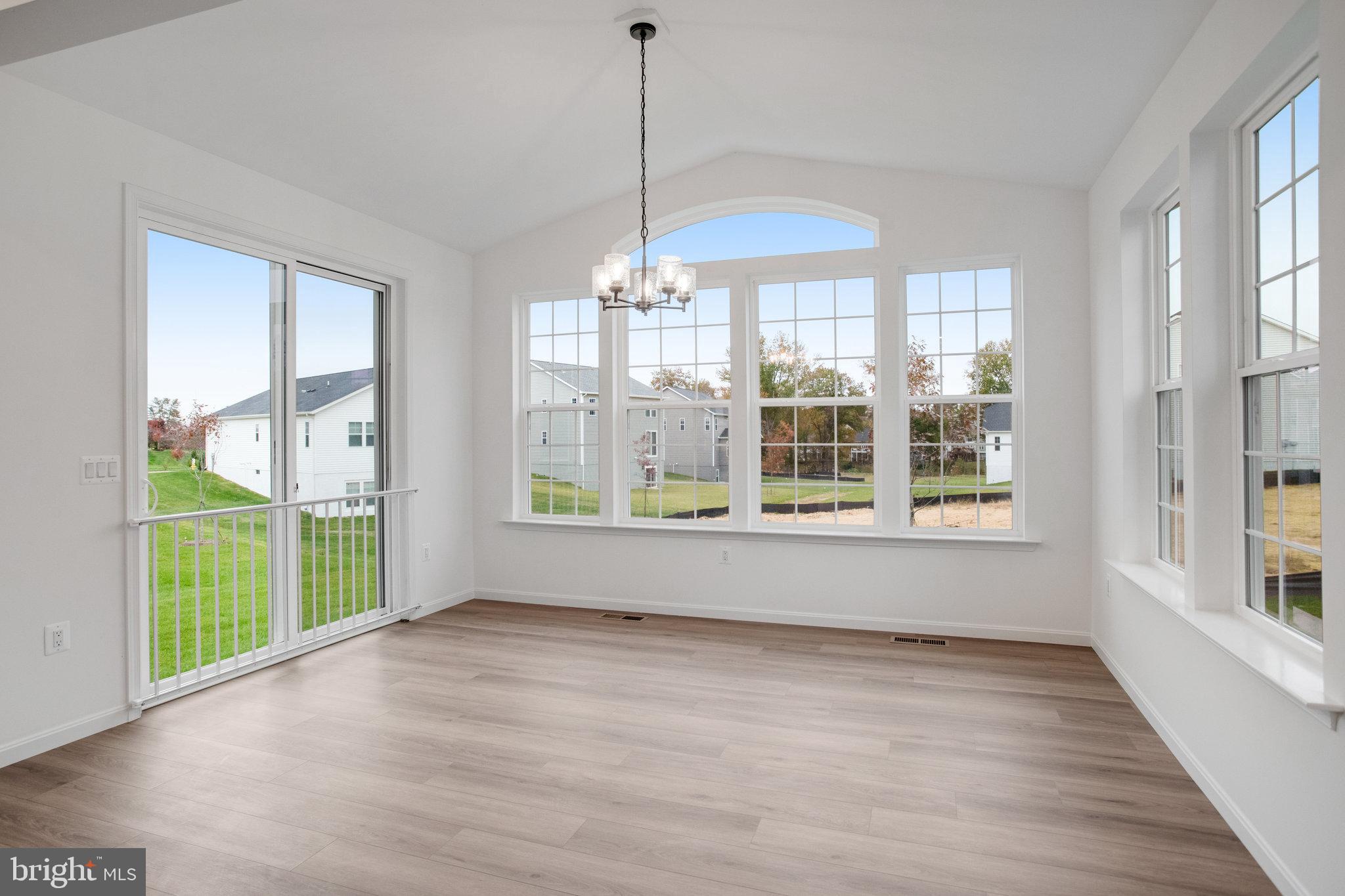 2009 Divot Drive Culpeper, VA 22701 - Photo 16 of 46 a view of an empty room with wooden floor and a window