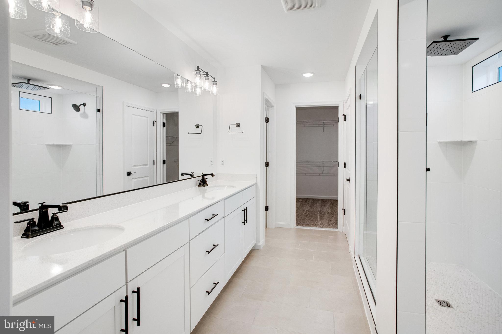 2009 Divot Drive Culpeper, VA 22701 - Photo 24 of 46 a bathroom with double vanity sink and a mirror