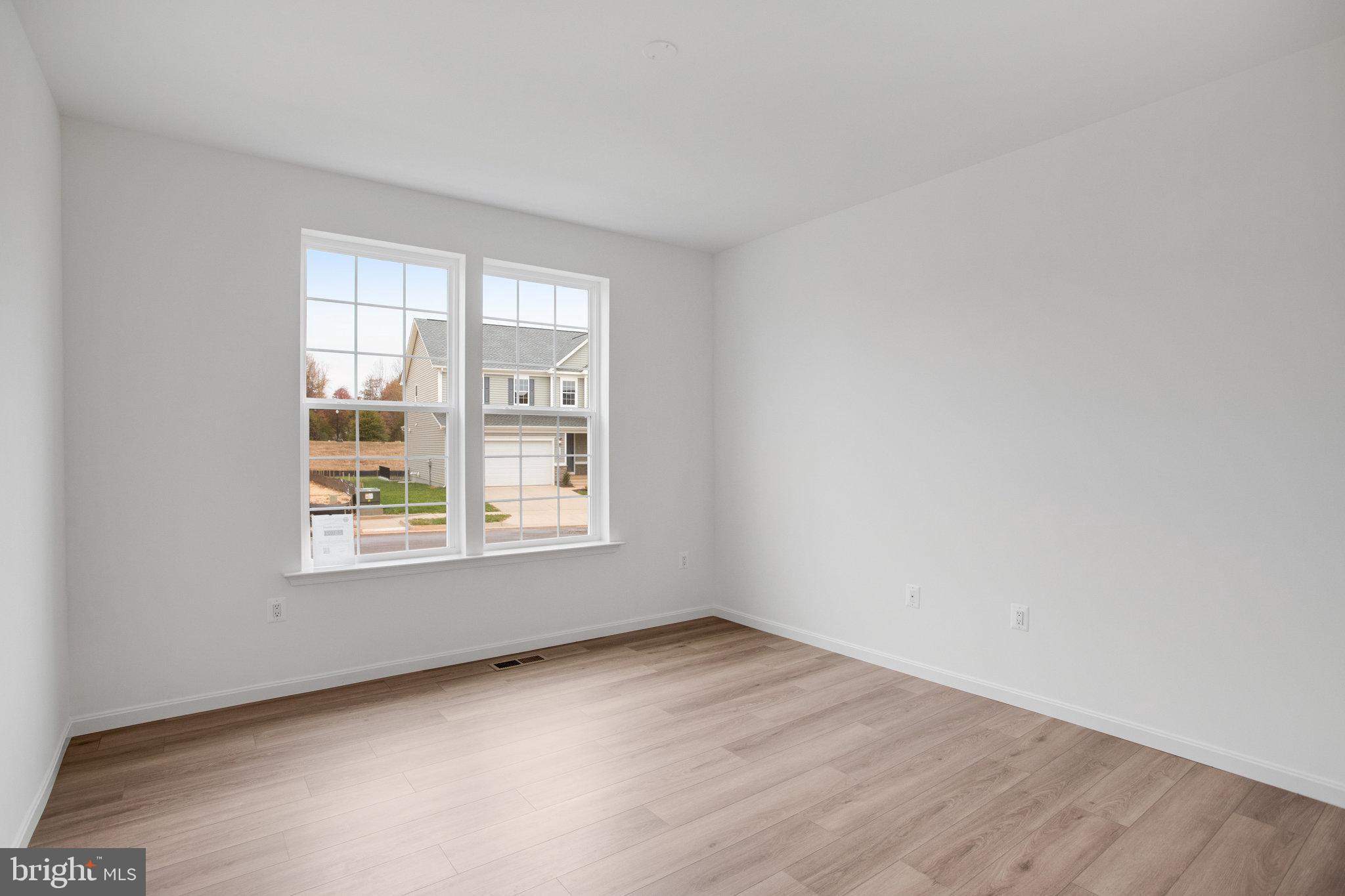 2009 Divot Drive Culpeper, VA 22701 - Photo 5 of 46 an empty room with wooden floor and windows
