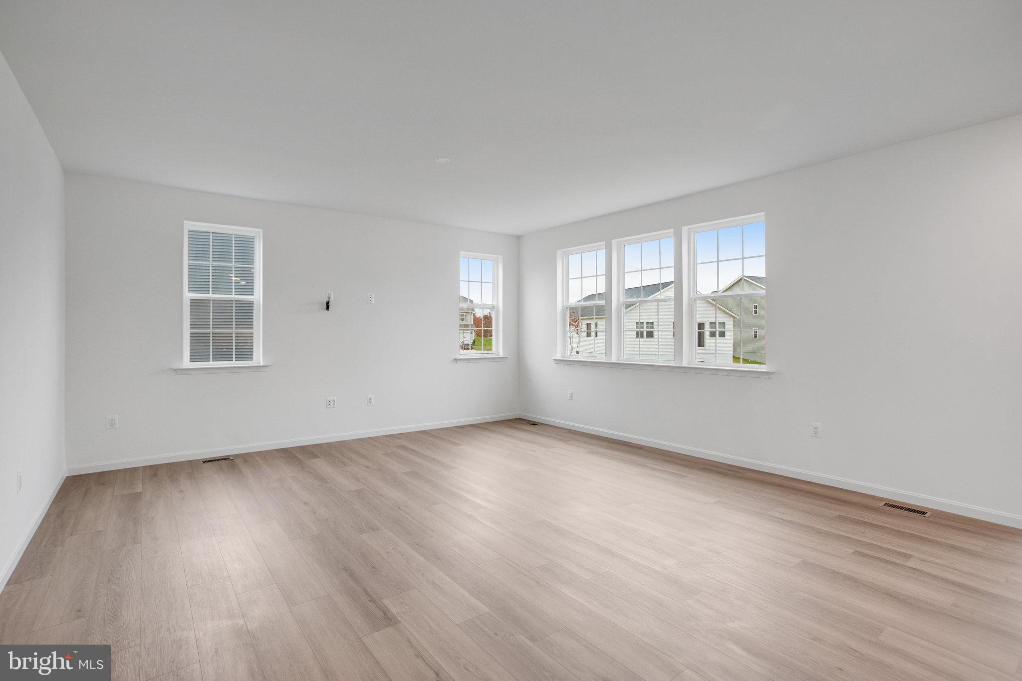 2009 Divot Drive Culpeper, VA 22701 - Photo 9 of 46 an empty room with wooden floor and windows