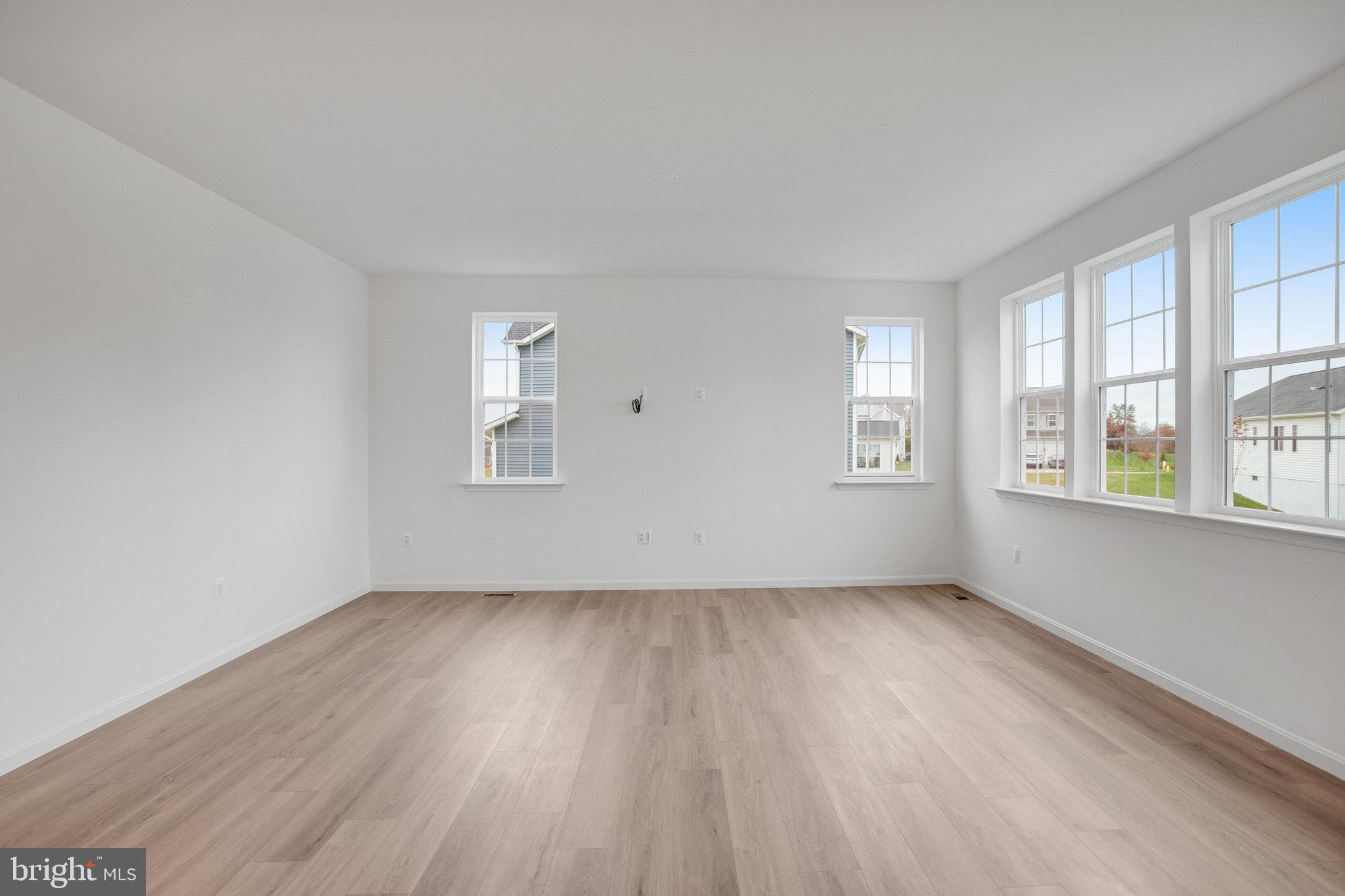 2009 Divot Drive Culpeper, VA 22701 - Photo 10 of 46 a view of an empty room with wooden floor and a window