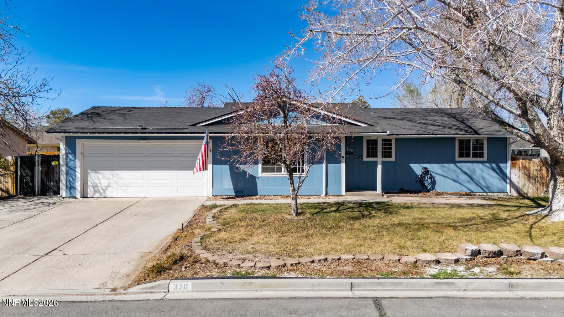 370 Maple Street Fernley, NV 89408 - Photo 1 of 32 a front view of a house with a yard