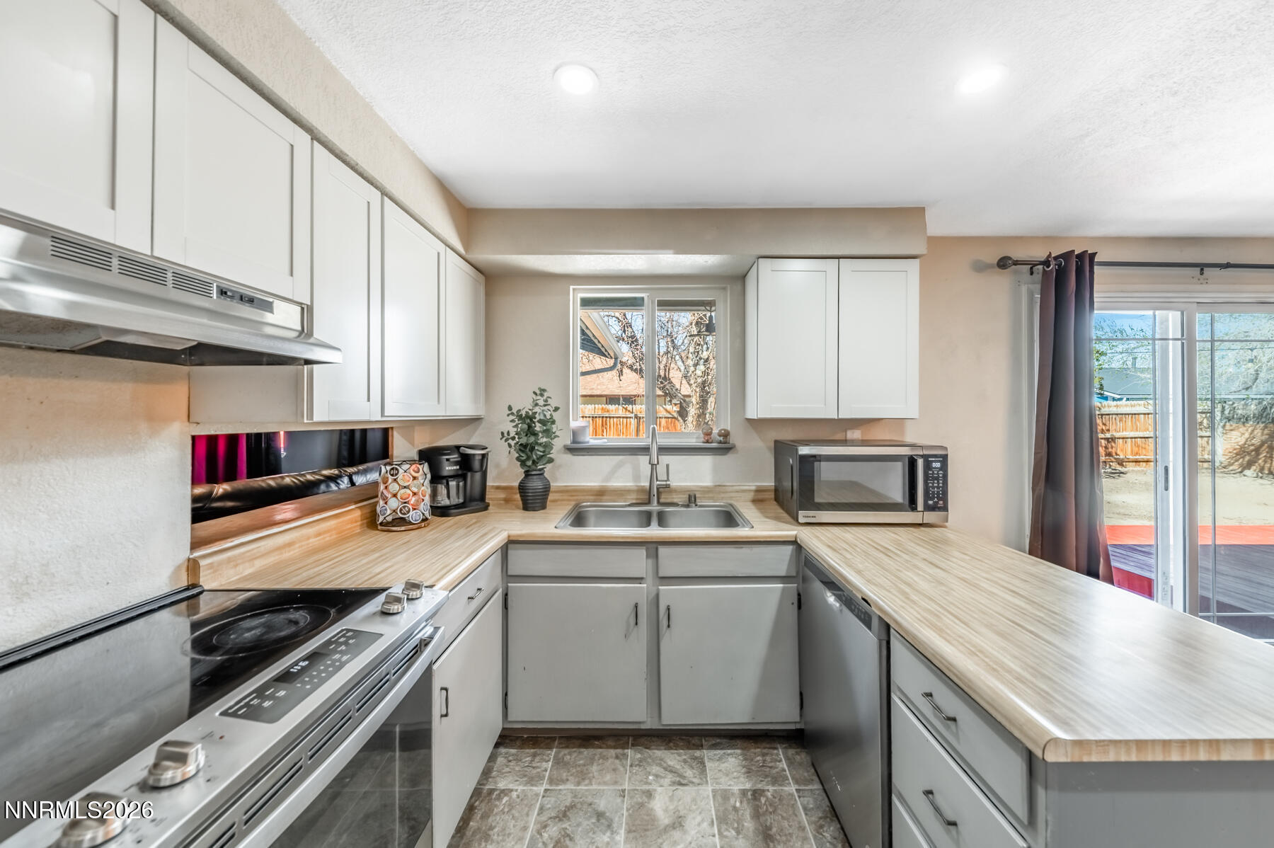 370 Maple Street Fernley, NV 89408 - Photo 11 of 32 a kitchen with a sink stove top oven and cabinets
