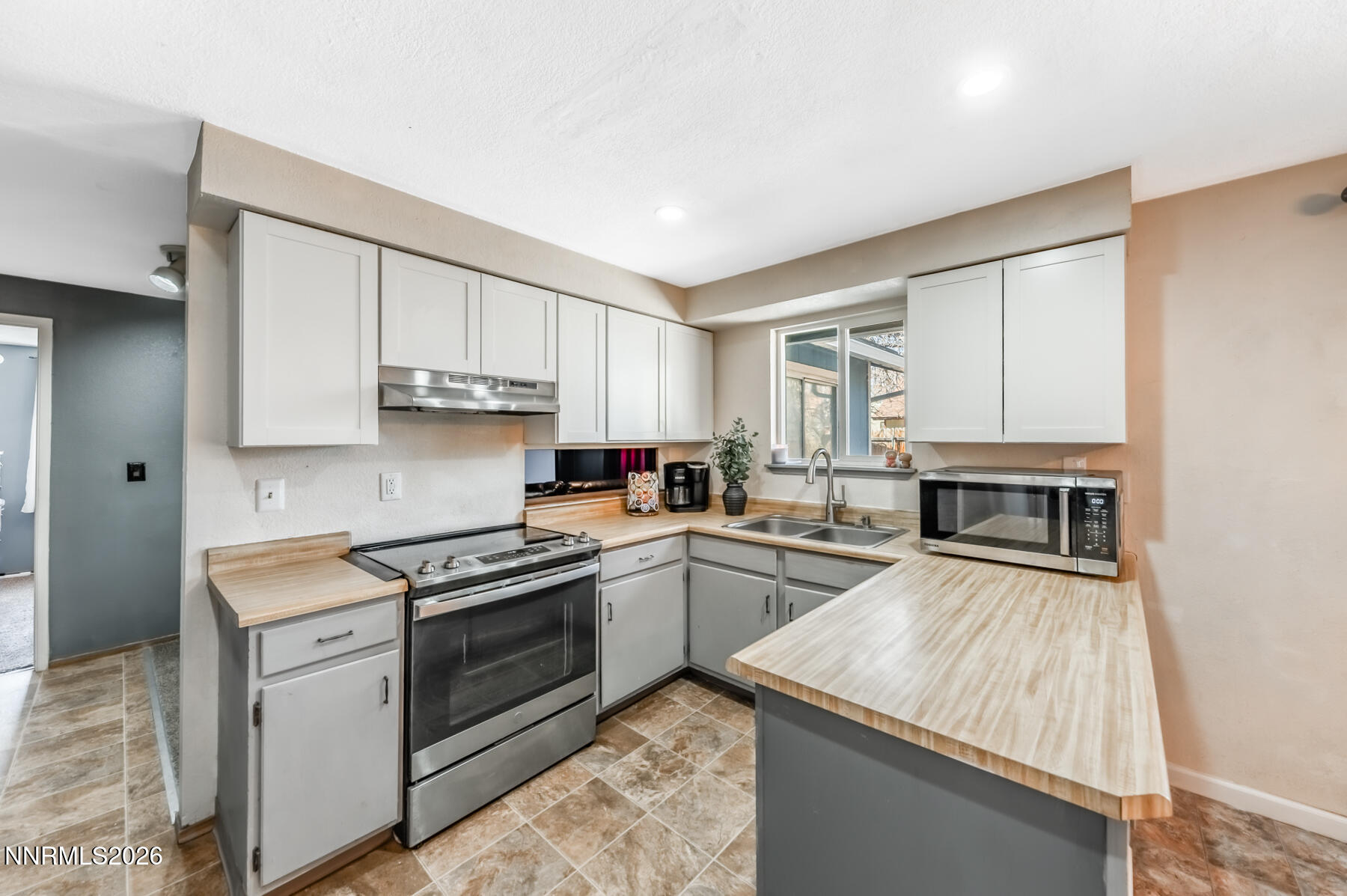 370 Maple Street Fernley, NV 89408 - Photo 12 of 32 a kitchen with a stove sink and cabinets