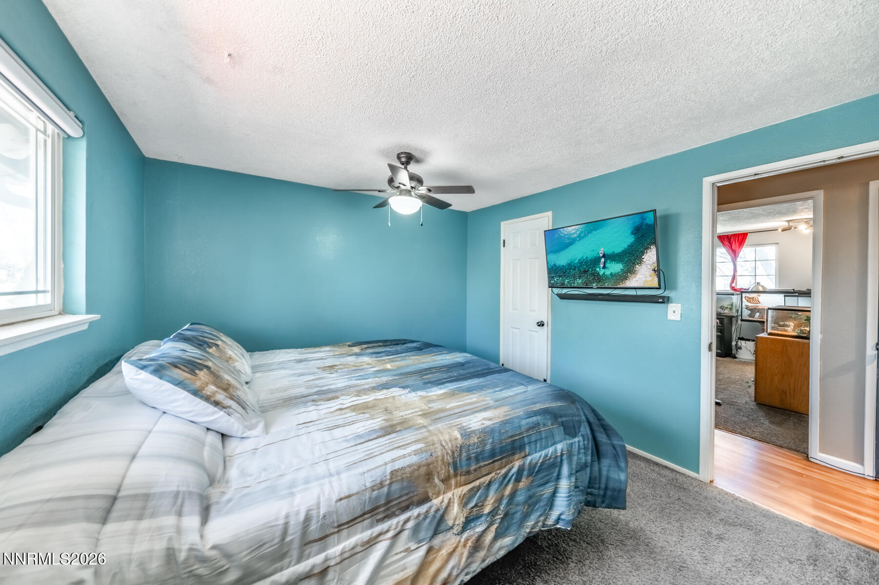 370 Maple Street Fernley, NV 89408 - Photo 16 of 32 a bedroom with a bed and a chandelier