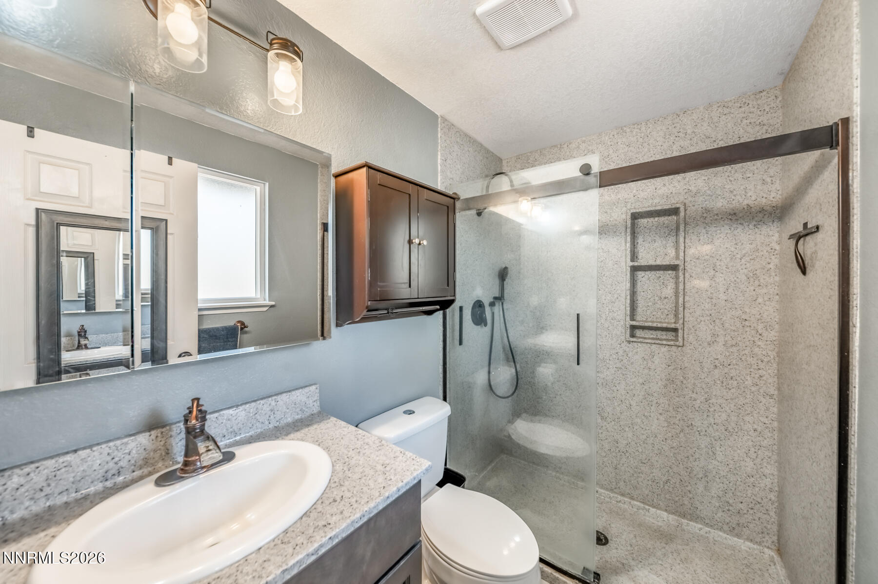 370 Maple Street Fernley, NV 89408 - Photo 17 of 32 a bathroom with a granite countertop sink toilet and shower