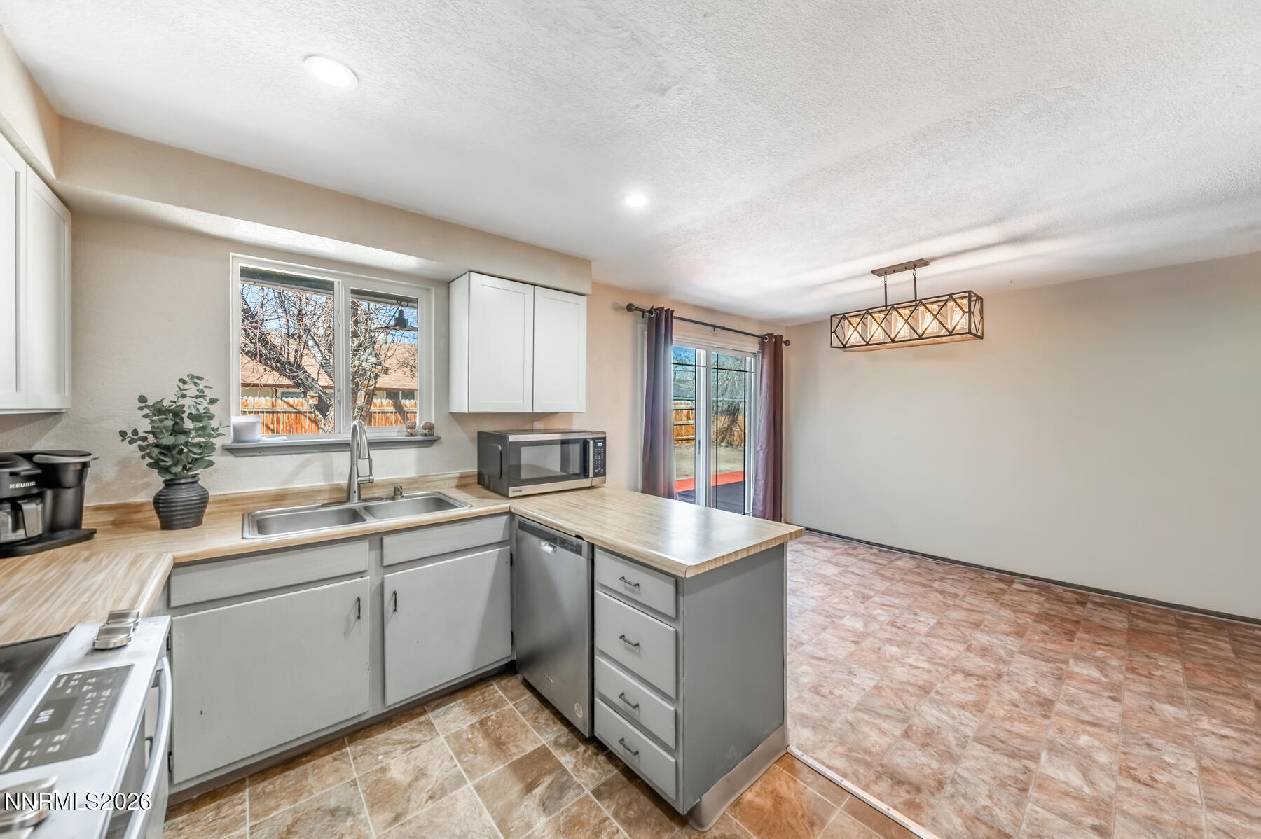 370 Maple Street Fernley, NV 89408 - Photo 9 of 32 a kitchen with a sink stove and cabinets