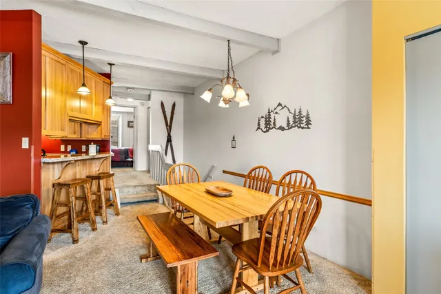 a dining room with furniture and a chandelier