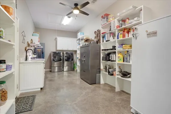 a view of a livingroom with fridge and workspace