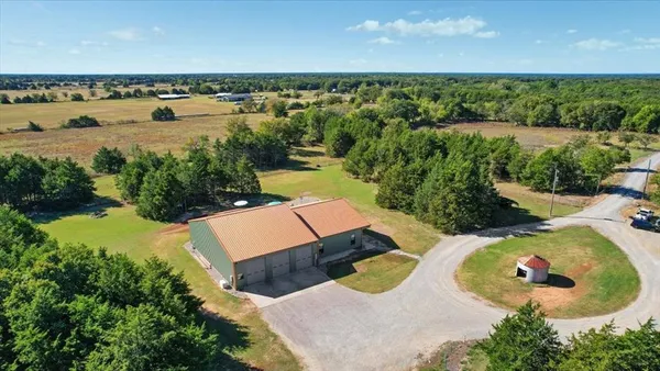 an aerial view of a house with a lake view