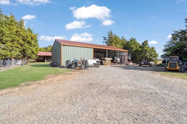 a view of backyard with wooden fence
