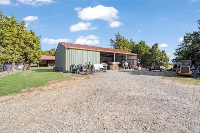 a view of backyard with wooden fence