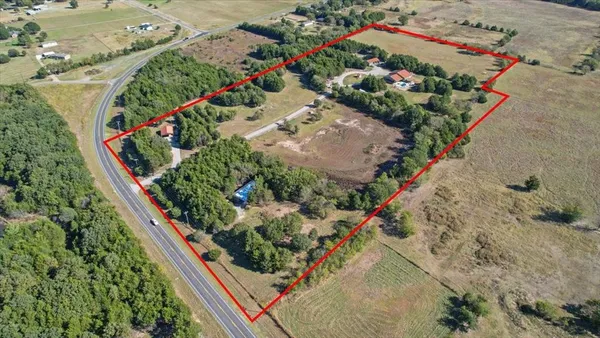 a view of lot of small space with large trees