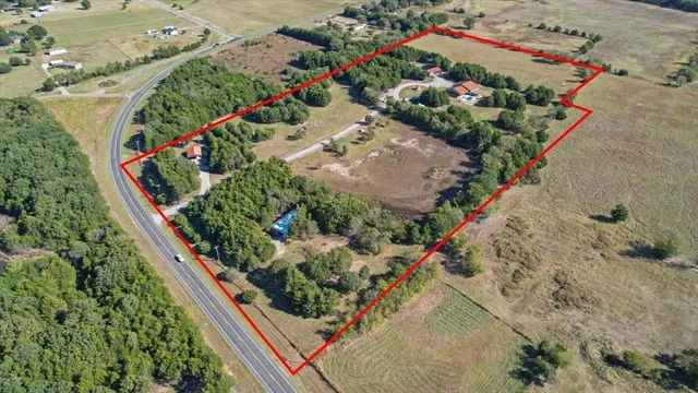 a view of lot of small space with large trees