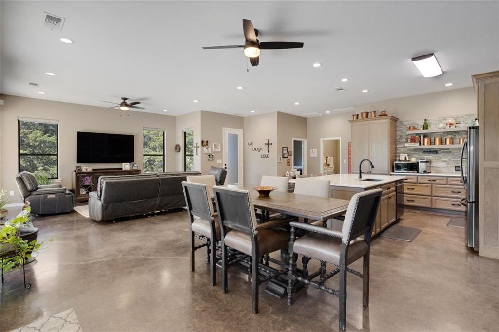 7250 North Fm 273 Ivanhoe, TX 75447 - Photo 5 of 40 a living room with furniture a flat screen tv and a kitchen