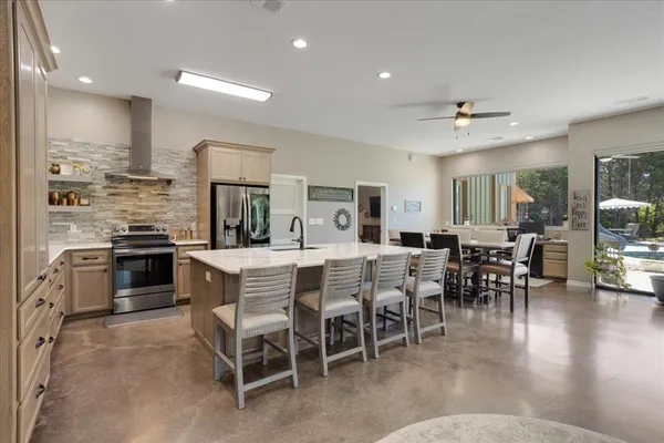 a large kitchen with a table and chairs