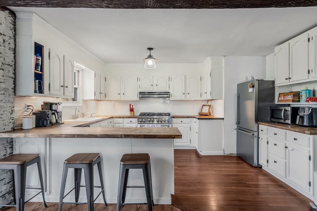 209 Lankford Road Cookeville, TN 38506 - Photo 12 of 38 a kitchen with stainless steel appliances granite countertop a white cabinets and wooden floor