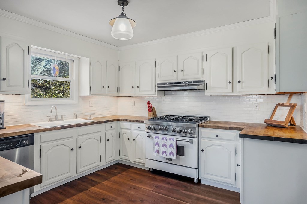 209 Lankford Road Cookeville, TN 38506 - Photo 13 of 38 a kitchen with stainless steel appliances granite countertop a sink a stove and cabinets with wooden floor