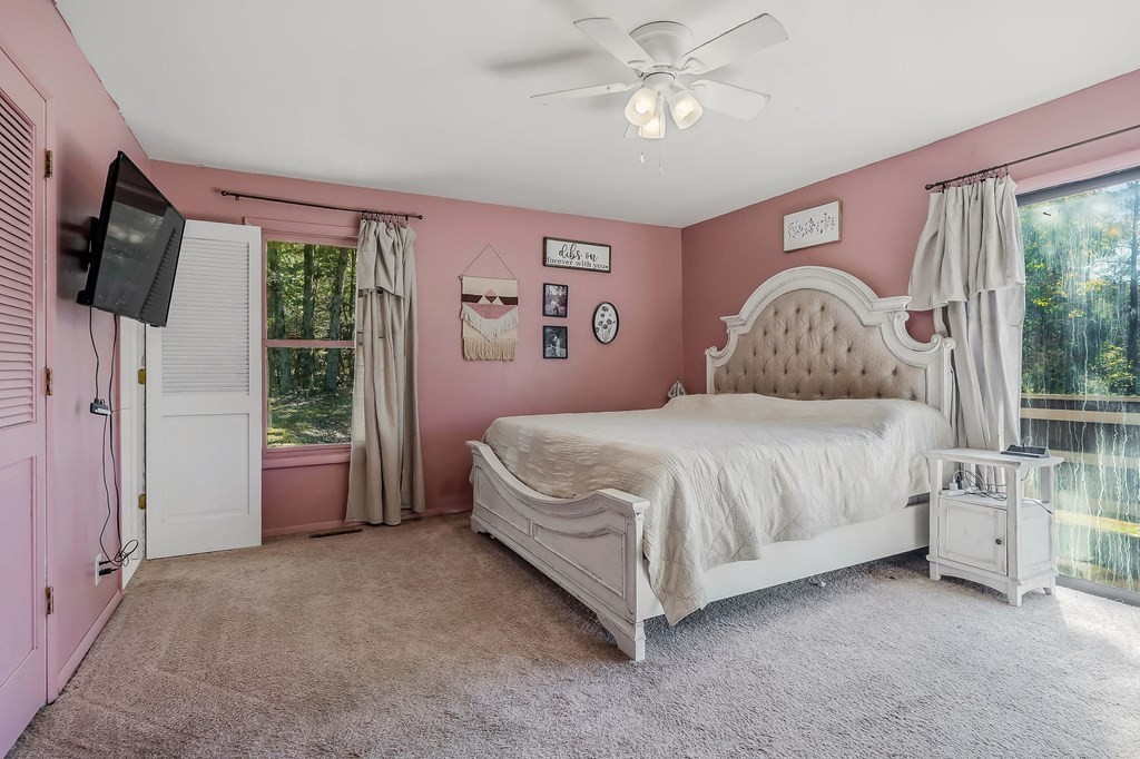 209 Lankford Road Cookeville, TN 38506 - Photo 15 of 38 a spacious bedroom with a bed flat screen tv and a large window