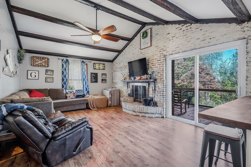 209 Lankford Road Cookeville, TN 38506 - Photo 10 of 38 a living room with furniture a flat screen tv and a floor to ceiling window