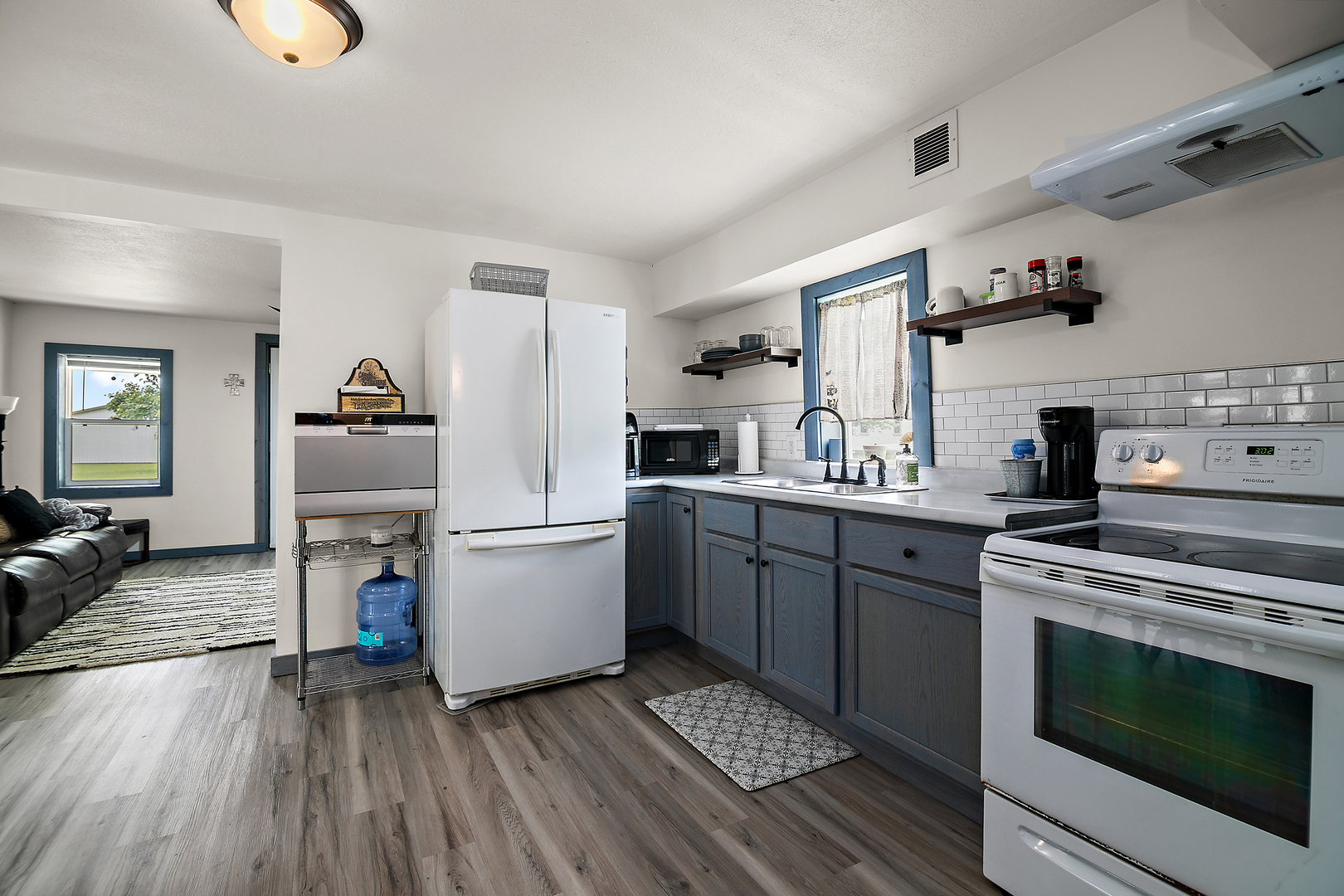 1506 East 2710 North Road Clifton, IL 60927 - Photo 6 of 21 a kitchen with a refrigerator and a stove top oven