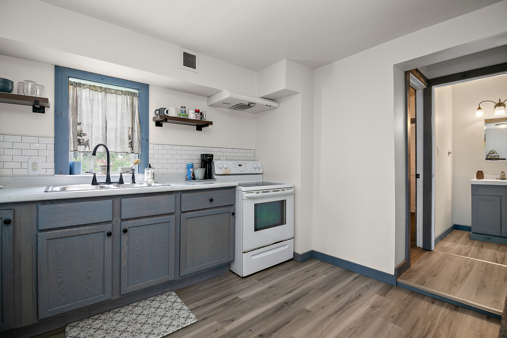 1506 East 2710 North Road Clifton, IL 60927 - Photo 7 of 21 a kitchen with a sink cabinets and wooden floor