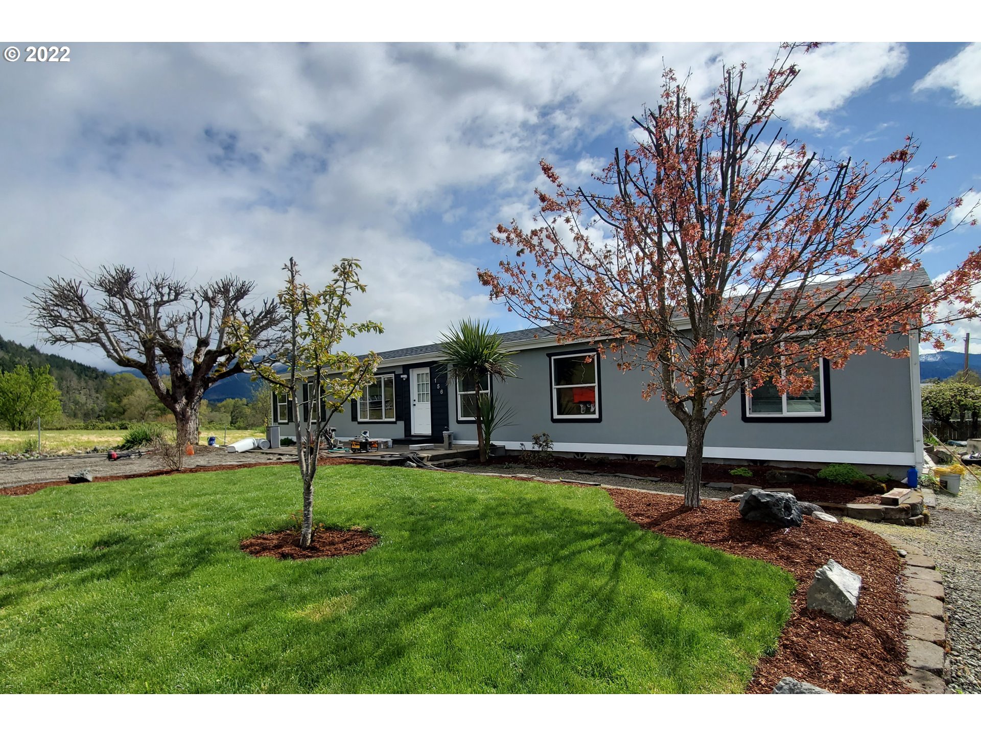 156 Oak Street Riddle, OR 97469 - Photo 1 of 23 a backyard of a house with lots of green space