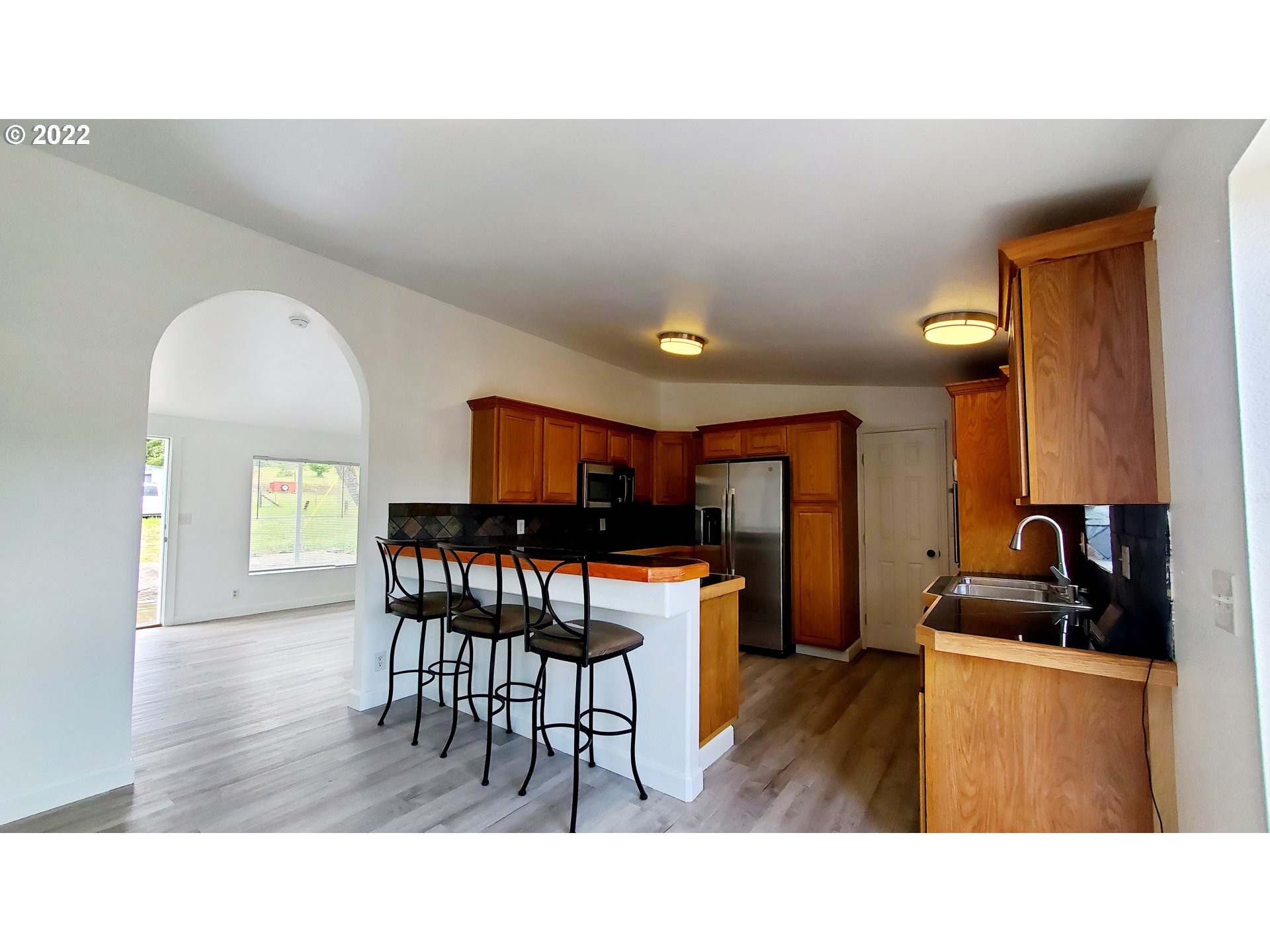 156 Oak Street Riddle, OR 97469 - Photo 10 of 23 a kitchen with a table and chairs in it