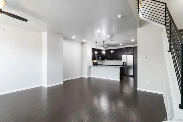 a view of a kitchen with kitchen island a sink stainless steel appliances and cabinets