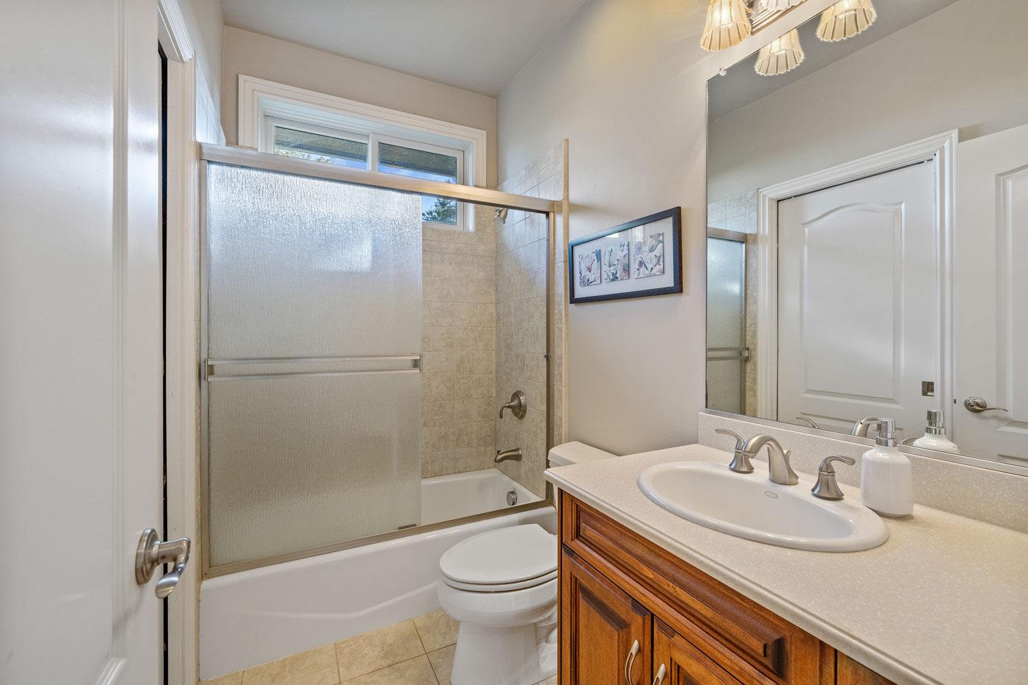 5288 West Kile Road Lodi, CA 95242 - Photo 14 of 45 a bathroom with a granite countertop sink toilet and shower