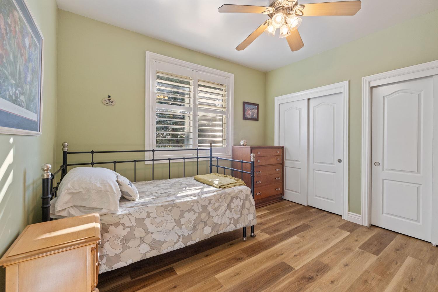 5288 West Kile Road Lodi, CA 95242 - Photo 15 of 45 a bedroom with a bed and a chandelier