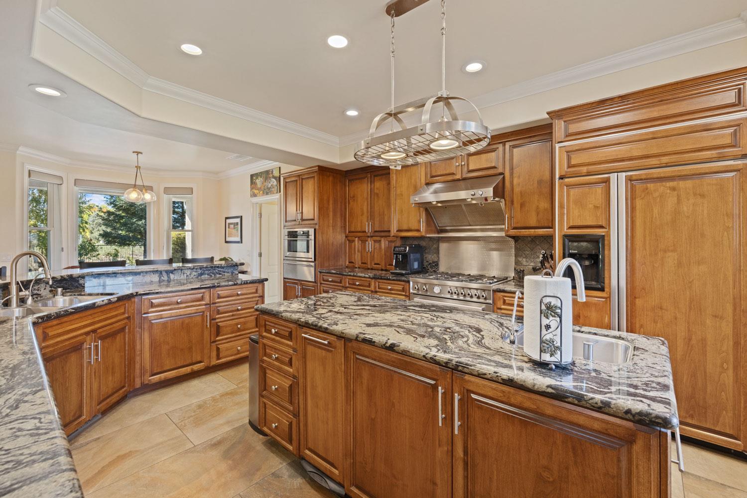 5288 West Kile Road Lodi, CA 95242 - Photo 25 of 45 a kitchen with stainless steel appliances granite countertop a sink and stove