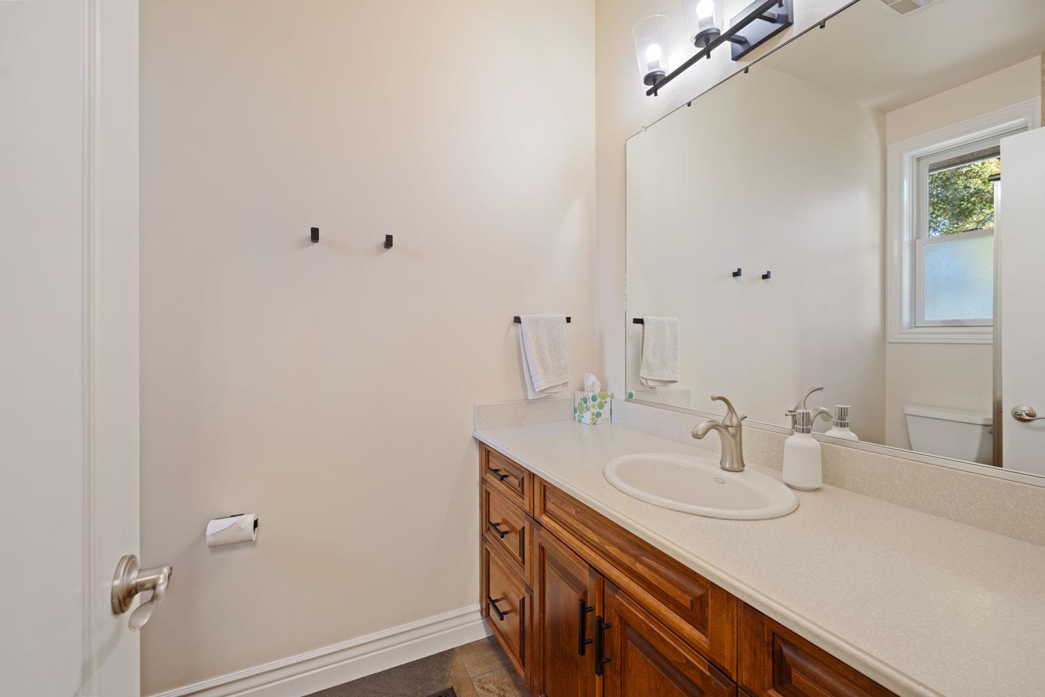 5288 West Kile Road Lodi, CA 95242 - Photo 28 of 45 a bathroom with a sink and a mirror