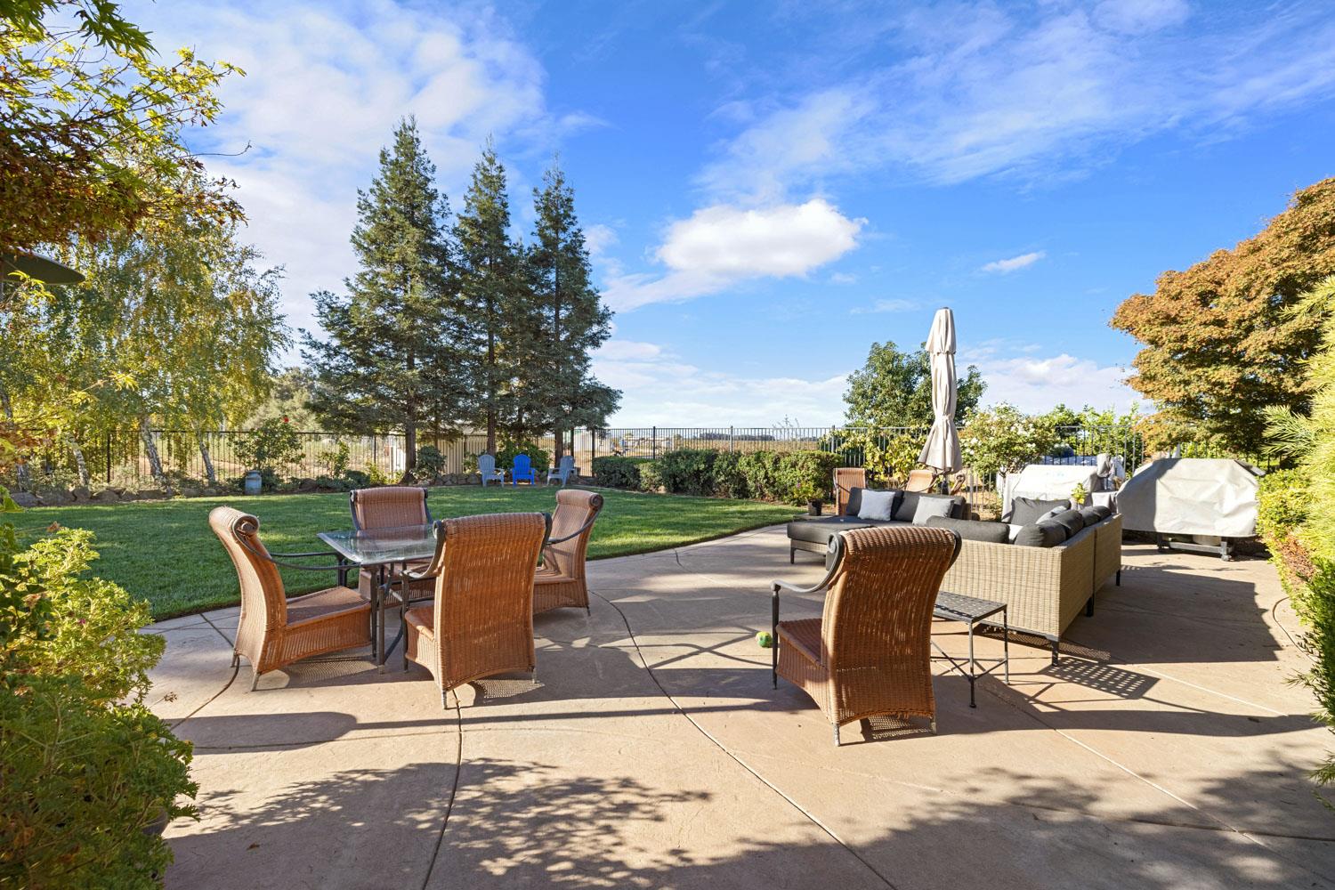5288 West Kile Road Lodi, CA 95242 - Photo 29 of 45 a view of a patio with a table chairs and a fire pit