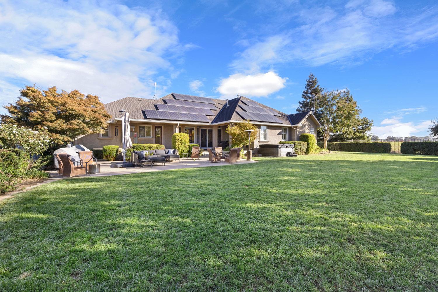 5288 West Kile Road Lodi, CA 95242 - Photo 40 of 45 a front view of a house with a garden and outdoor seating