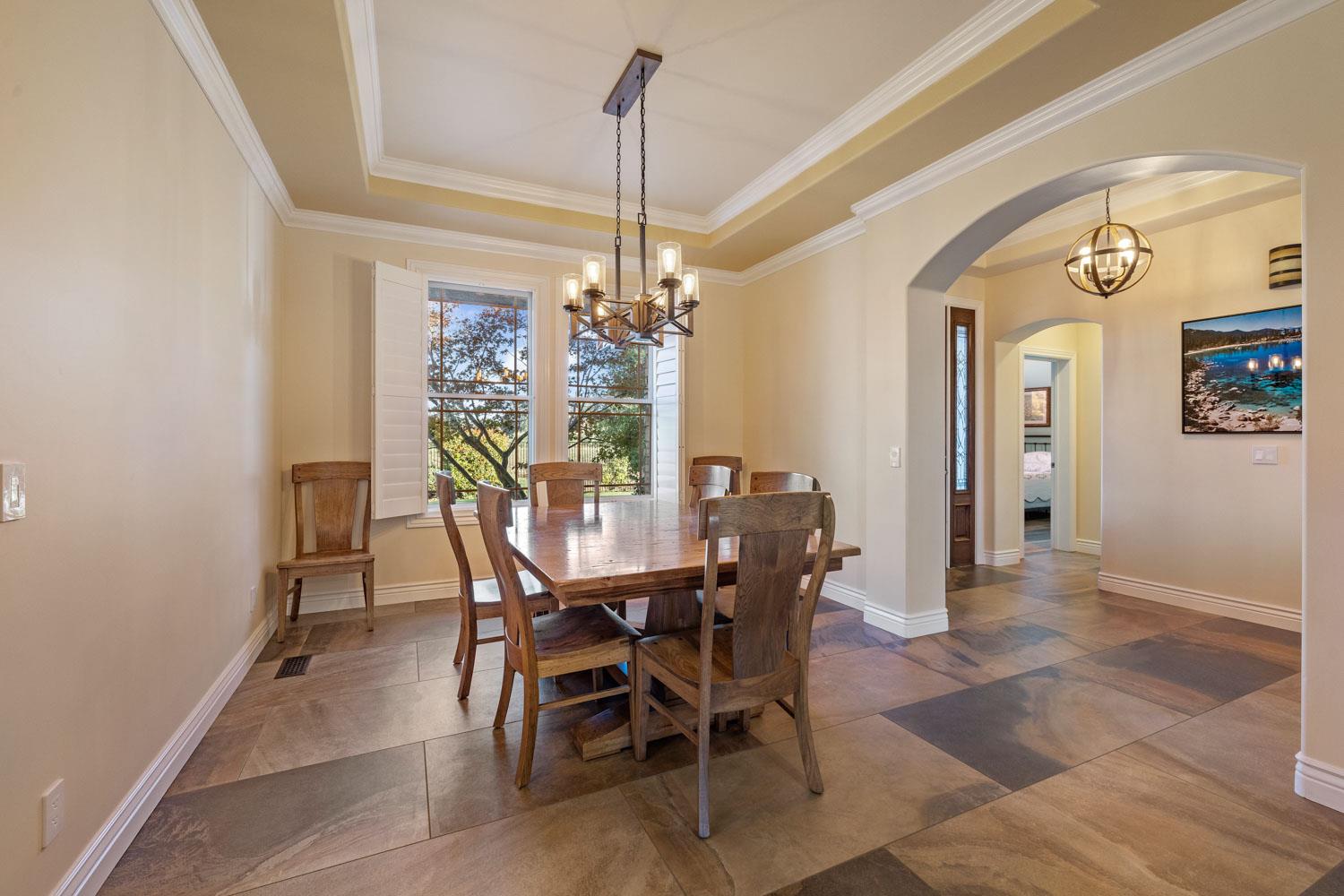 5288 West Kile Road Lodi, CA 95242 - Photo 9 of 45 a view of a dining room with furniture and a chandelier