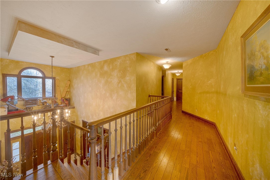 10000 Wisner Road Willoughby, OH 44094 - Photo 17 of 32 Corridor with light hardwood / wood-style floors and a textured ceiling