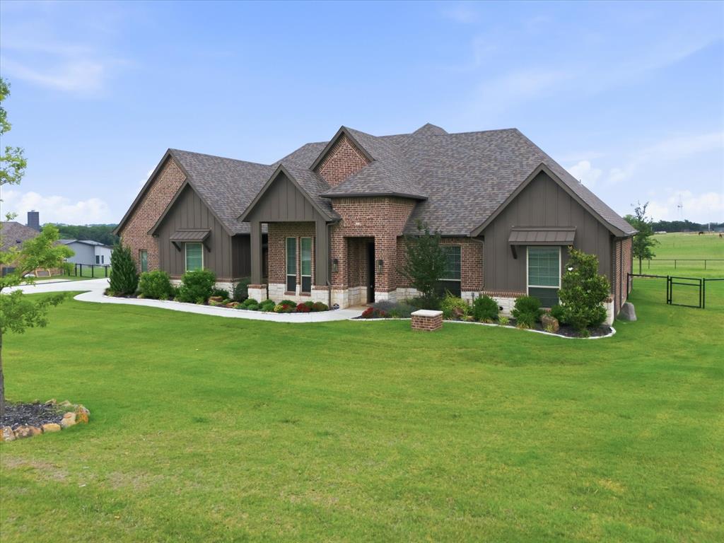 150 Quail Ridge Decatur, TX 76234 - Photo 2 of 32 a front view of a house with garden and porch