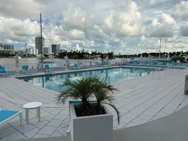 a view of a lake with chairs